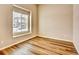 Bright bedroom features a large window and sleek wood flooring at 885 Hearthstone Ave, Brighton, CO 80601