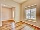Entryway with wood-look flooring leads to the front door and a window at 885 Hearthstone Ave, Brighton, CO 80601