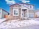 Charming two-story home featuring a stone facade, covered entrance, and attached garage in a suburban neighborhood at 885 Hearthstone Ave, Brighton, CO 80601