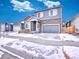 Beautiful two-story home with stone accents, a covered porch, and an attached two-car garage at 885 Hearthstone Ave, Brighton, CO 80601