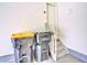 Garage interior featuring access door to stairs with some garbage cans at 885 Hearthstone Ave, Brighton, CO 80601