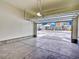Spacious garage with concrete floors, featuring open door with neighborhood view at 885 Hearthstone Ave, Brighton, CO 80601