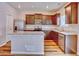 Modern kitchen boasts stainless steel appliances, granite countertops, and a functional island at 885 Hearthstone Ave, Brighton, CO 80601