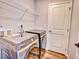 Laundry room with Samsung washer and dryer set, wire shelving, and a white door at 885 Hearthstone Ave, Brighton, CO 80601
