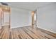 Spacious living room with open doorways and wood-look flooring at 885 Hearthstone Ave, Brighton, CO 80601