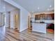 Open concept living space features wood-look flooring and an adjacent kitchen at 885 Hearthstone Ave, Brighton, CO 80601