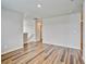 Large living room features wood-look floors and open access to other areas at 885 Hearthstone Ave, Brighton, CO 80601