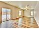 Spacious living room with sliding glass door and a ceiling fan at 885 Hearthstone Ave, Brighton, CO 80601