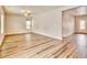 Open living room boasts hardwood flooring and natural light at 885 Hearthstone Ave, Brighton, CO 80601