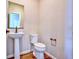Clean powder room with pedestal sink and modern fixtures for convenience and style at 885 Hearthstone Ave, Brighton, CO 80601