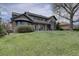 Well-maintained home with manicured lawn and mature tree providing shade and curb appeal to the rear exterior at 14993 W 55Th Dr, Golden, CO 80403