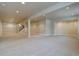 Spacious finished basement with neutral carpet, structural supports, and recessed lighting at 14993 W 55Th Dr, Golden, CO 80403