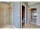 Tiled bathroom featuring a glass shower and separate water closet at 14993 W 55Th Dr, Golden, CO 80403