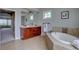 Bright bathroom with double vanity, soaking tub, and neutral tile at 14993 W 55Th Dr, Golden, CO 80403