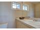 Bathroom featuring a vanity with tile countertop, sink, and natural light at 14993 W 55Th Dr, Golden, CO 80403