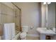 Bathroom featuring a shower-tub combo and pedestal sink at 14993 W 55Th Dr, Golden, CO 80403