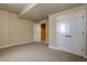 A bedroom showcasing neutral tones and a view into an adjacent room and large white double doors at 14993 W 55Th Dr, Golden, CO 80403