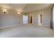 Spacious bedroom featuring vaulted ceilings, neutral carpeting, and ensuite bathroom access at 14993 W 55Th Dr, Golden, CO 80403