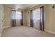 A spacious bedroom with neutral tones and window with sheer and color accenting curtains at 14993 W 55Th Dr, Golden, CO 80403