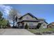 Traditional two-story home showcasing an attached three-car garage, manicured landscaping, and a spacious driveway at 14993 W 55Th Dr, Golden, CO 80403
