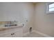 Practical laundry area with a sink and tiled backsplash at 14993 W 55Th Dr, Golden, CO 80403