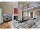 Elegant living room with fireplace, tall ceilings and lots of comfortable seating at 14993 W 55Th Dr, Golden, CO 80403