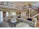 Inviting living room featuring a large sectional sofa, hardwood floors, and open layout at 14993 W 55Th Dr, Golden, CO 80403