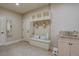 Functional mud room featuring storage cubbies, bench seating, and a utility sink at 14993 W 55Th Dr, Golden, CO 80403