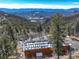 Breathtaking aerial view of a mountain home with solar panels and stunning views of the surrounding landscape at 11450 Marks Dr, Conifer, CO 80433