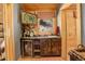 Charming bar area with custom cabinets and a wine refrigerator, perfect for entertaining guests at 11450 Marks Dr, Conifer, CO 80433