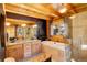 Well-lit bathroom with double sinks, a soaking tub, and a glass-enclosed shower at 11450 Marks Dr, Conifer, CO 80433