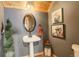 Rustic bathroom features a pedestal sink, charming decor, and wood accents at 11450 Marks Dr, Conifer, CO 80433