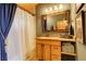 Well-appointed bathroom featuring wood cabinetry, granite countertop, and a shower at 11450 Marks Dr, Conifer, CO 80433