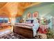 Cozy bedroom featuring custom bedding, a window seat, and wood accents at 11450 Marks Dr, Conifer, CO 80433