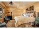 Comfortable bedroom featuring stylish furniture, a large bed, and unique artwork at 11450 Marks Dr, Conifer, CO 80433