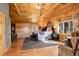 Well-lit bedroom features hardwood floors, a ceiling fan, and an area rug at 11450 Marks Dr, Conifer, CO 80433