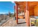 Scenic deck featuring a hot tub, comfortable seating, and mountain views at 11450 Marks Dr, Conifer, CO 80433