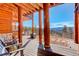 Spacious wooden deck with mountain views and outdoor seating at 11450 Marks Dr, Conifer, CO 80433