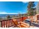 Deck with mountain view, seating, and wooden railing perfect for outdoor entertaining and relaxation at 11450 Marks Dr, Conifer, CO 80433