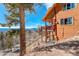 Exterior view of mountain home featuring deck, hot tub, and scenic views at 11450 Marks Dr, Conifer, CO 80433