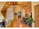 Well-lit hallway with hardwood floors leads to various rooms and features stone accent wall at 11450 Marks Dr, Conifer, CO 80433