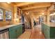Gourmet kitchen with a center island, custom green cabinetry, modern appliances, and wood accents at 11450 Marks Dr, Conifer, CO 80433