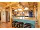 Kitchen with granite counters, stainless steel appliances, a large island, and wood beam accents at 11450 Marks Dr, Conifer, CO 80433