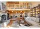 Spacious living room featuring high ceilings, a stone fireplace, and an open floor plan at 11450 Marks Dr, Conifer, CO 80433
