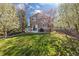 Beautifully landscaped backyard with a lush lawn, mature trees, patio, and wooden fence at 5941 S Waco St, Aurora, CO 80016