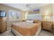 Bedroom with neutral tones, a ceiling fan, bedside tables with lamps and shutters on the window at 5941 S Waco St, Aurora, CO 80016
