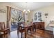 Dining room featuring sliding glass door to the deck and window with plantation shutters at 5941 S Waco St, Aurora, CO 80016