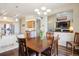 Open dining room featuring modern lighting, hardwood floors, and a view to the living room at 5941 S Waco St, Aurora, CO 80016