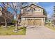 Charming two-story home featuring a two-car garage, mature landscaping, and a well-maintained lawn, creating great curb appeal at 5941 S Waco St, Aurora, CO 80016
