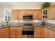 Modern kitchen with stainless steel appliances, granite countertops, and beautiful wood floors create an inviting space for cooking at 5941 S Waco St, Aurora, CO 80016
